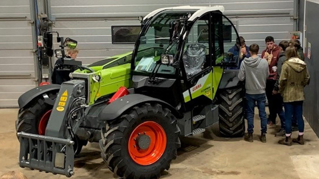 Young farmers checking out a CLAAS machine